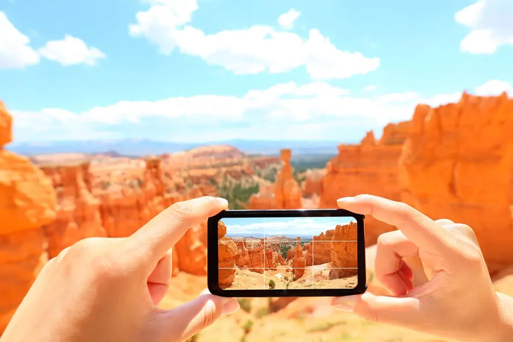person taking photo of landscape in American southwest with a smartphone, diagram explaining the rule of thirds in photography.