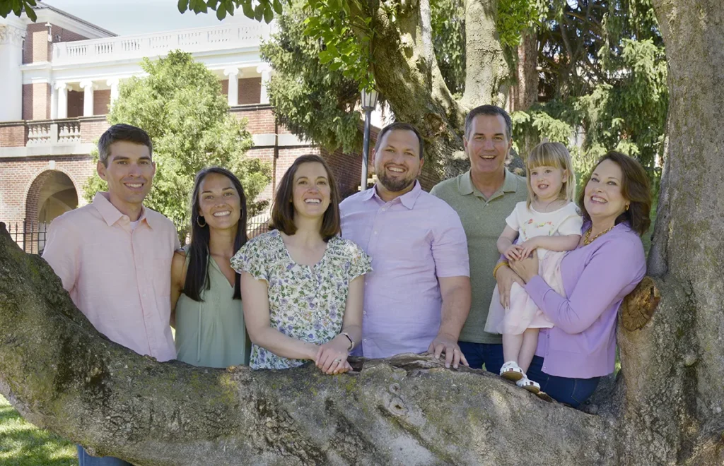 Family portrait behind a large tree branch.