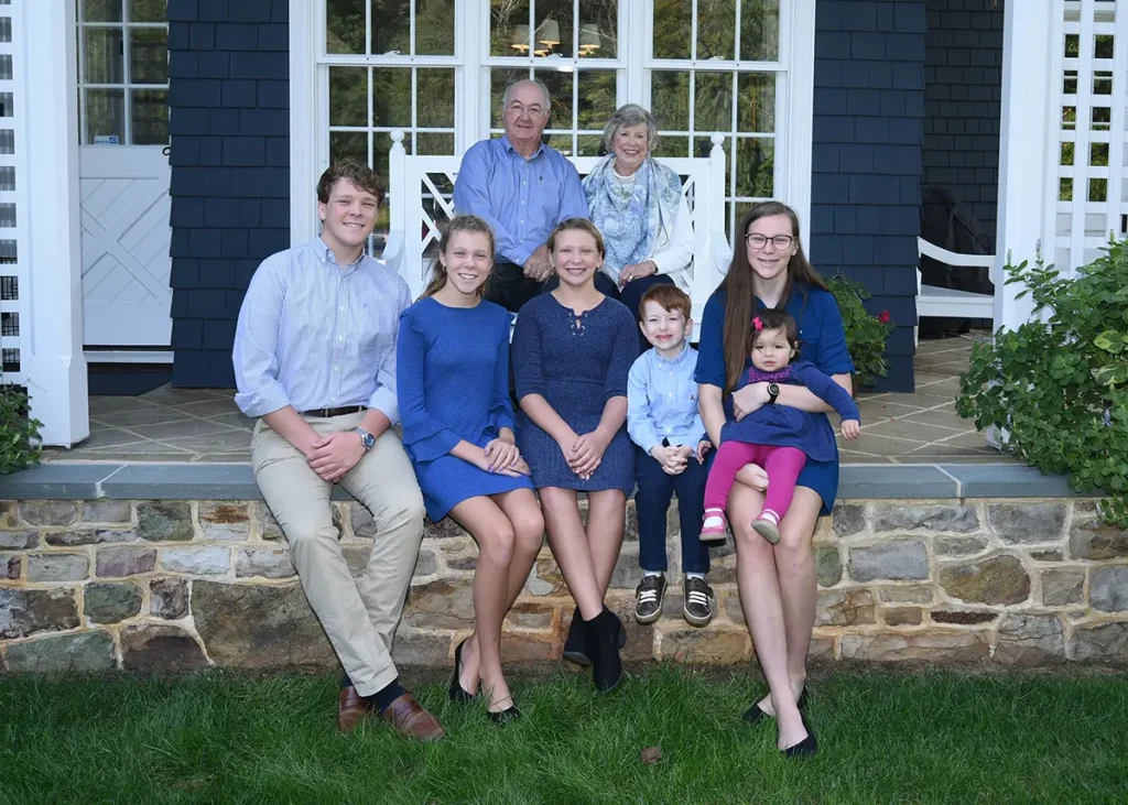 Portrait of happy family sitting on porch of house